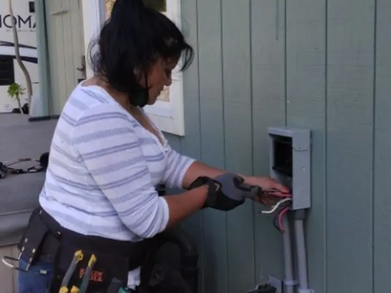 Licensed electrician wiring an exterior subpanel in Ghent