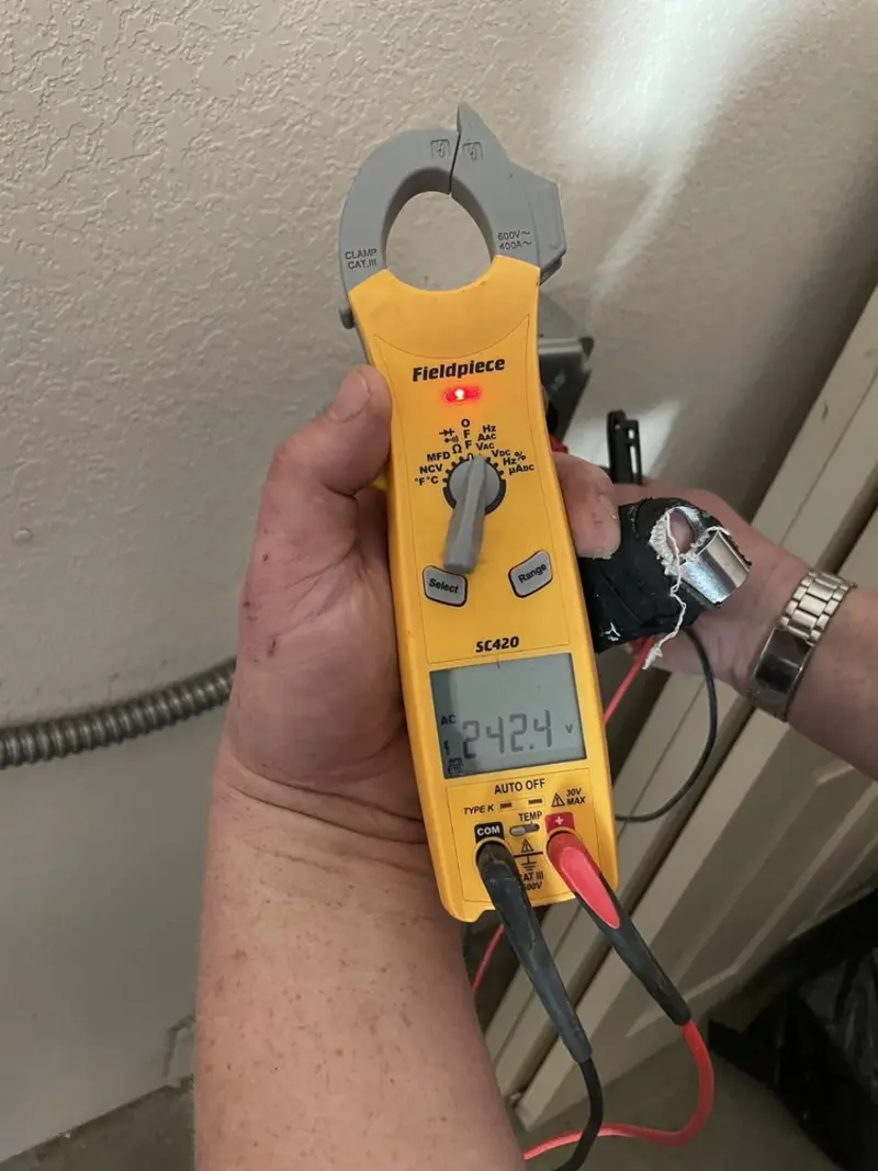 Voltage testing with clamp meter during Electrical Installation Services in Ghent